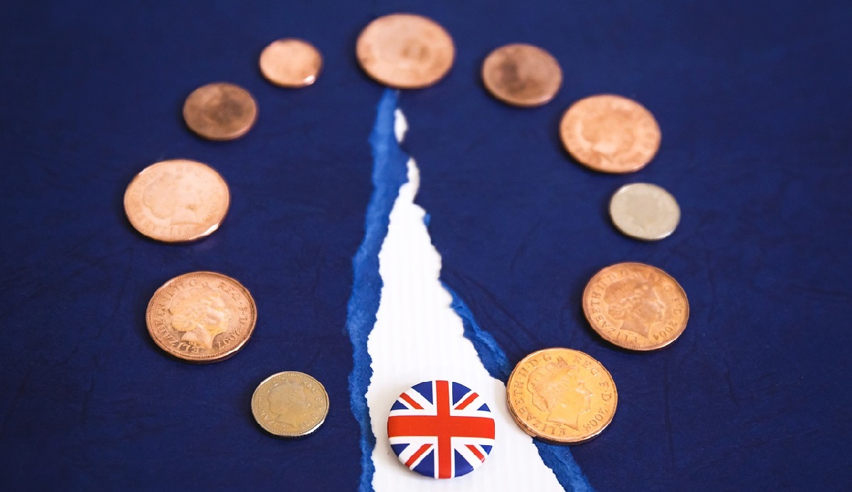 Coins and UK pin representing BREXIT negotiations